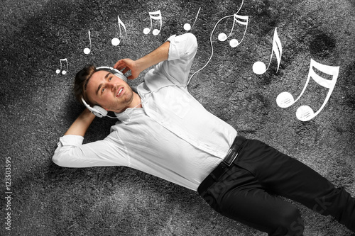 Young man lying on carpet a...