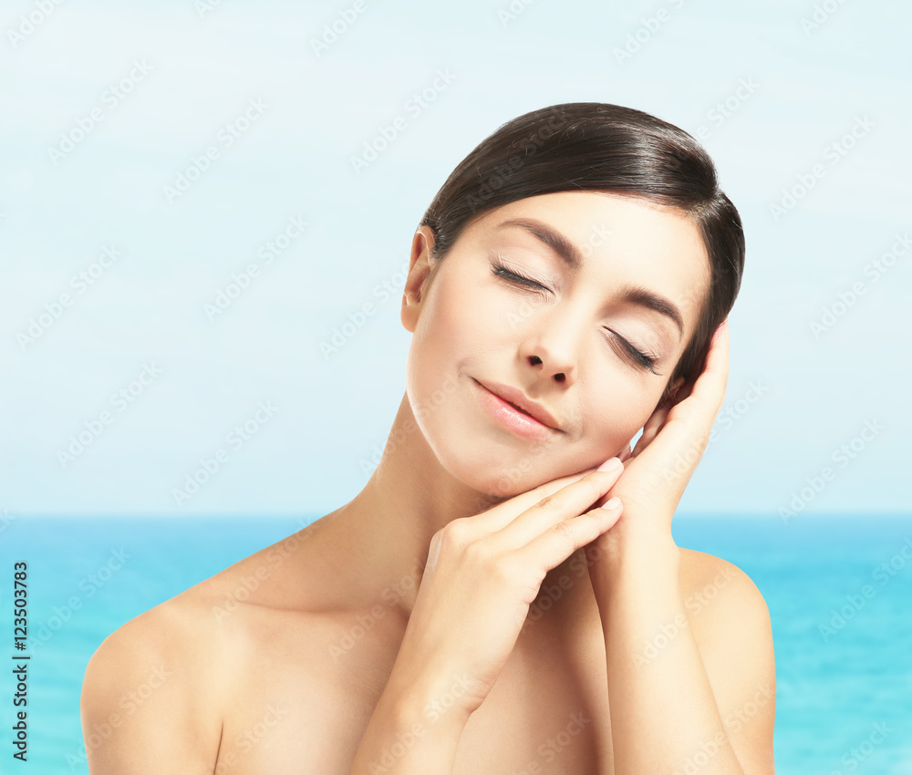 Pretty woman on blurred sea background Pretty woman on blurred sea background