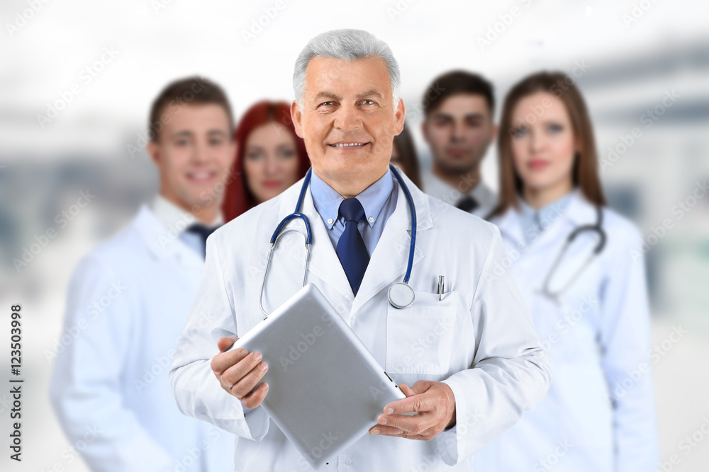 Doctor and medical team on blurred hospital background. Health care concept. Doctor and medical team on blurred hospital background. Health care concept.