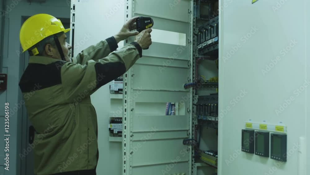 man doing electrical metering equipment man doing electrical metering equipment