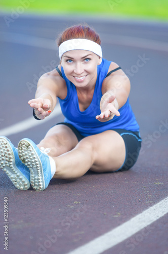 Portrait of Caucasian Female Athlete During Body Stretching Exercises photo