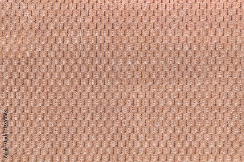 Light brown background from soft fleecy fabric closeup. Texture of textile macro.