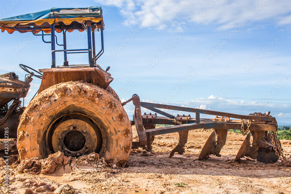 Fototapeta premium The image of the tractor in the mud