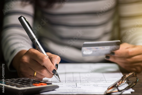 woman calculate how much cost or spending have with credit cards