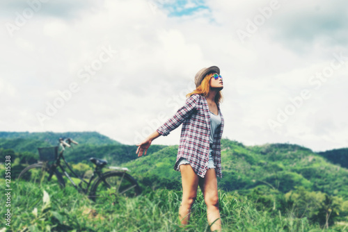 Young beautiful woman enjoying freedom and life in nature behind