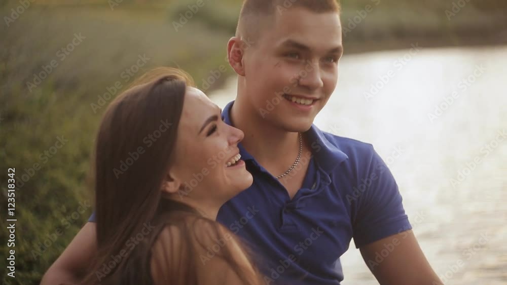 Romantic date. Couple in love on the shore near the water Romantic date. Couple in love on the shore near the water