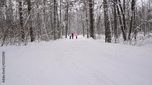 Wallpaper Mural Woman and two his children hold hands and run in the winter forest. Slow motion
 Torontodigital.ca