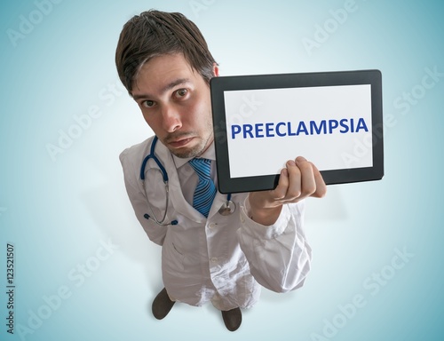 Doctor is warning against preeclampsia disease in pregnant patients. View from top. photo