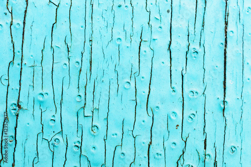 Old painted surface of the board. urquoise color, with large cracks. photo