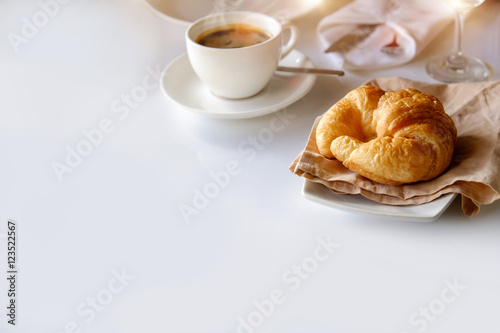 breakfast with croissants, cup of coffee.