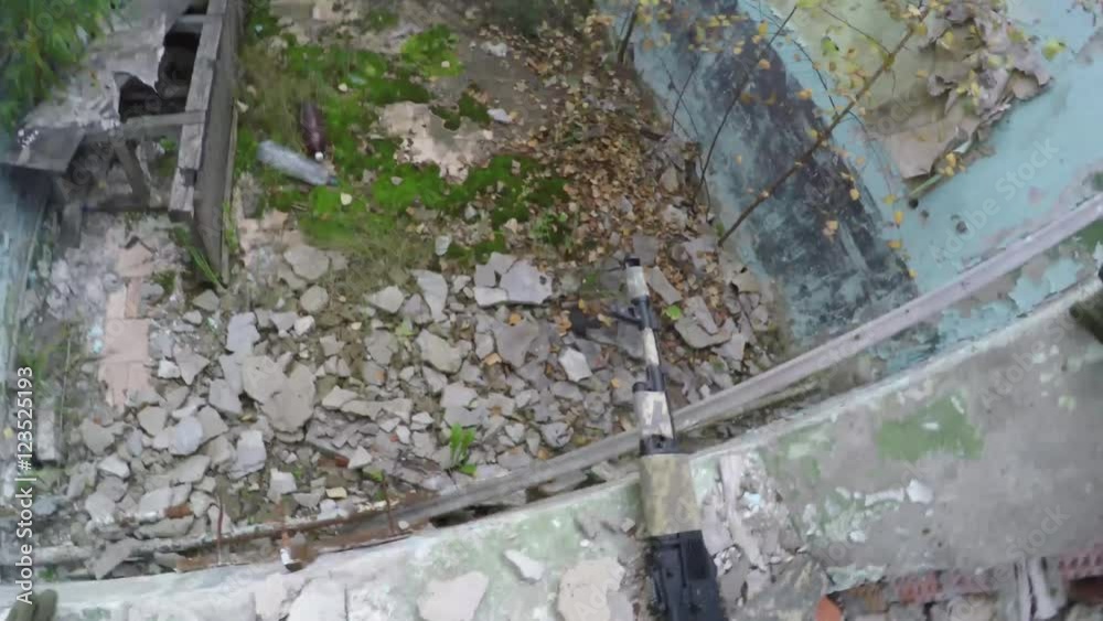 airsofter with automatic rifle climbs out the window. First-person view ...