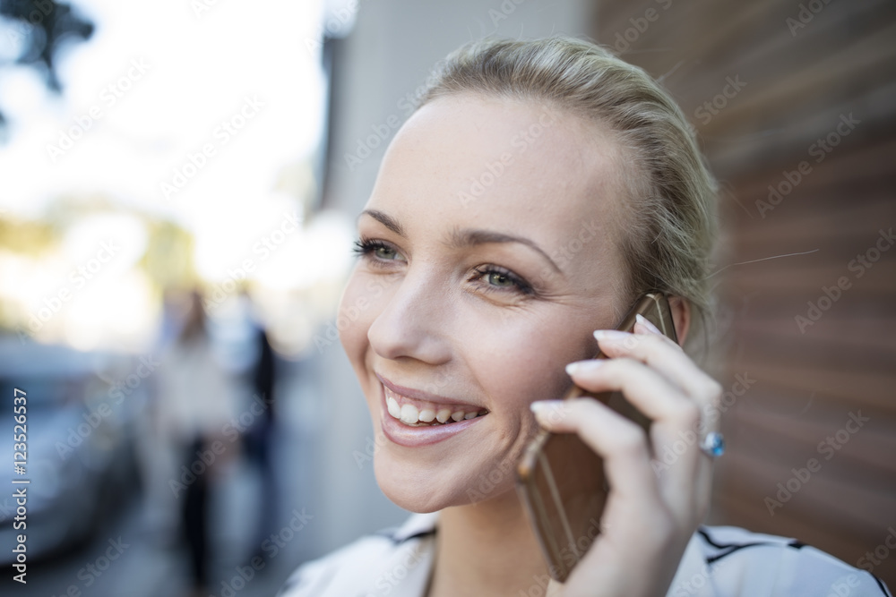 Smiling woman talking on cell phone Smiling woman talking on cell phone