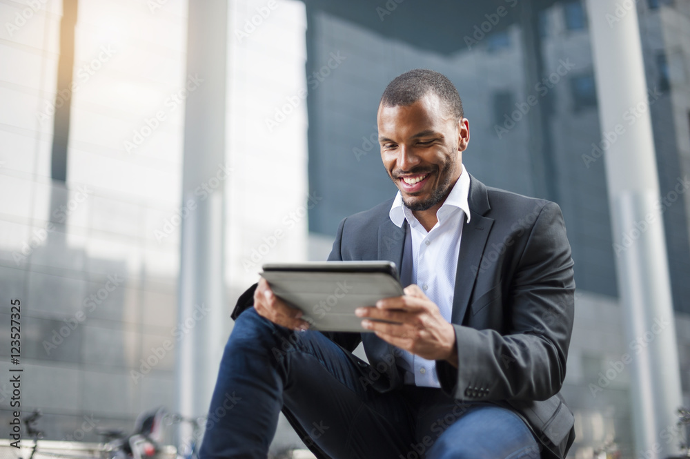 Smiling businessman using tablet Smiling businessman using tablet