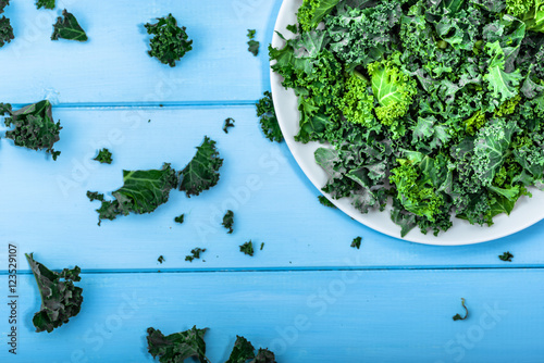 Green vegetable, leaves of kale from above on white plate