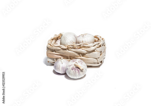 Garlic isolated on white in a basket