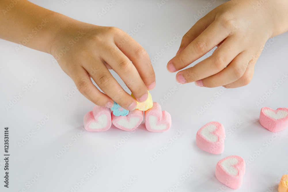 Child hands play jellys on white table Child hands play jellys on white table