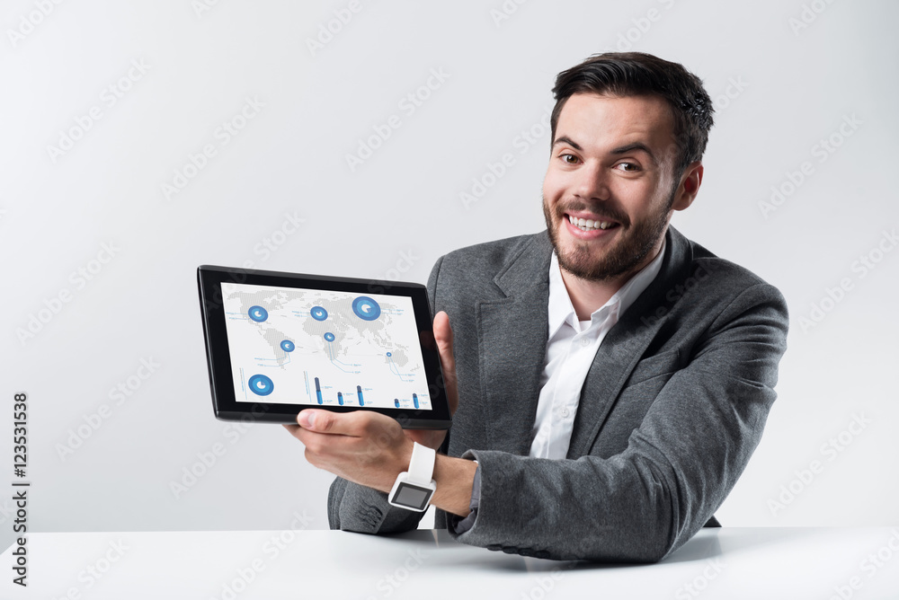 Smiling bearded man holding tablet Smiling bearded man holding tablet
