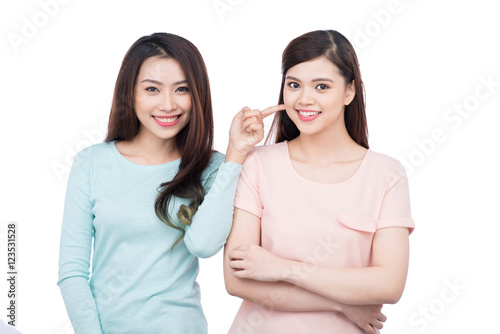 Two happy young female friends. Asian girls laughing.