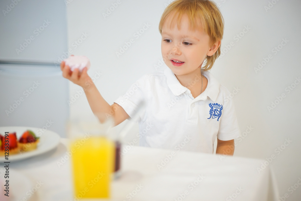 boy preparing breakfast in white kitchen boy preparing breakfast in white kitchen