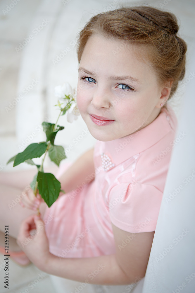 Portrait of beautiful little girl in a dress near the columns Portrait of beautiful little girl in a dress near the columns