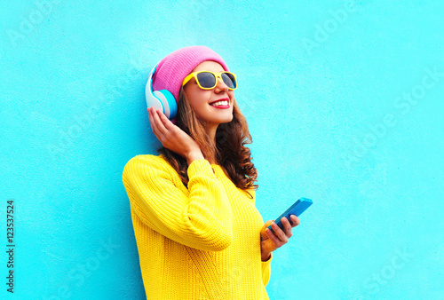 Fashion pretty sweet carefree girl listening to music in headpho