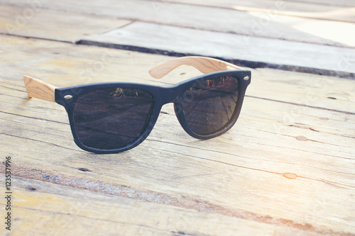 fashion sunglasses on wooden table