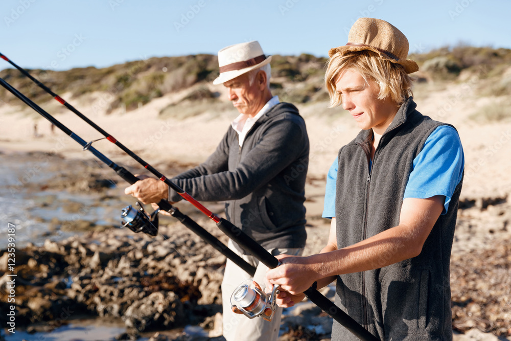 Senior man fishing with his grandson Senior man fishing with his grandson