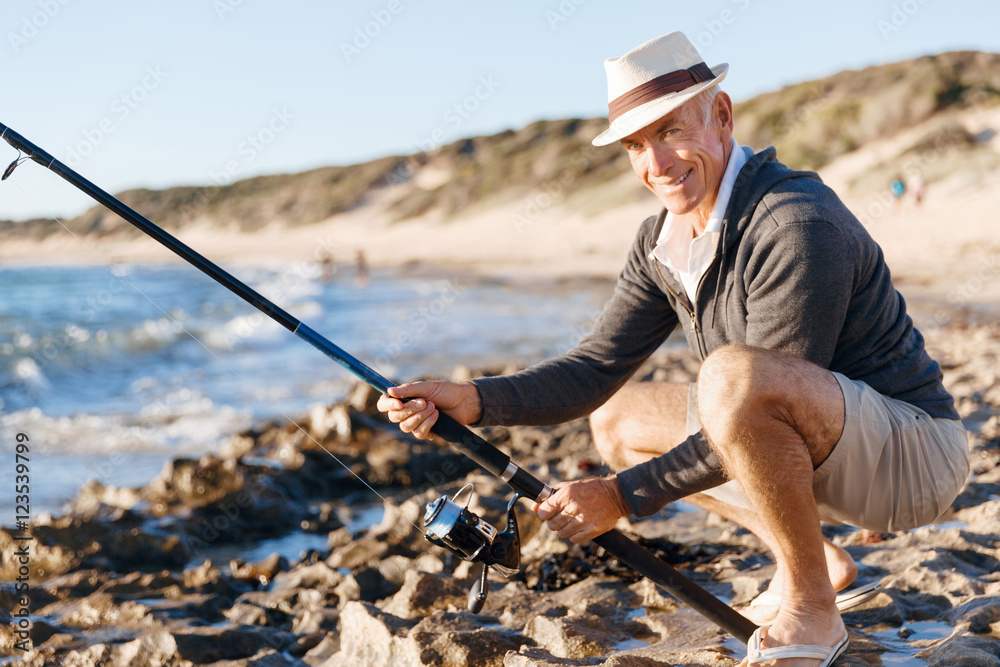 Senior man fishing at sea side Senior man fishing at sea side