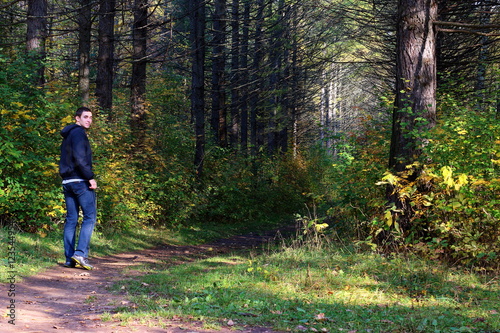 Man on trail. Man in autumn forest. Fall. Human