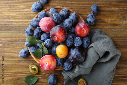 Ripe plums on rustic background