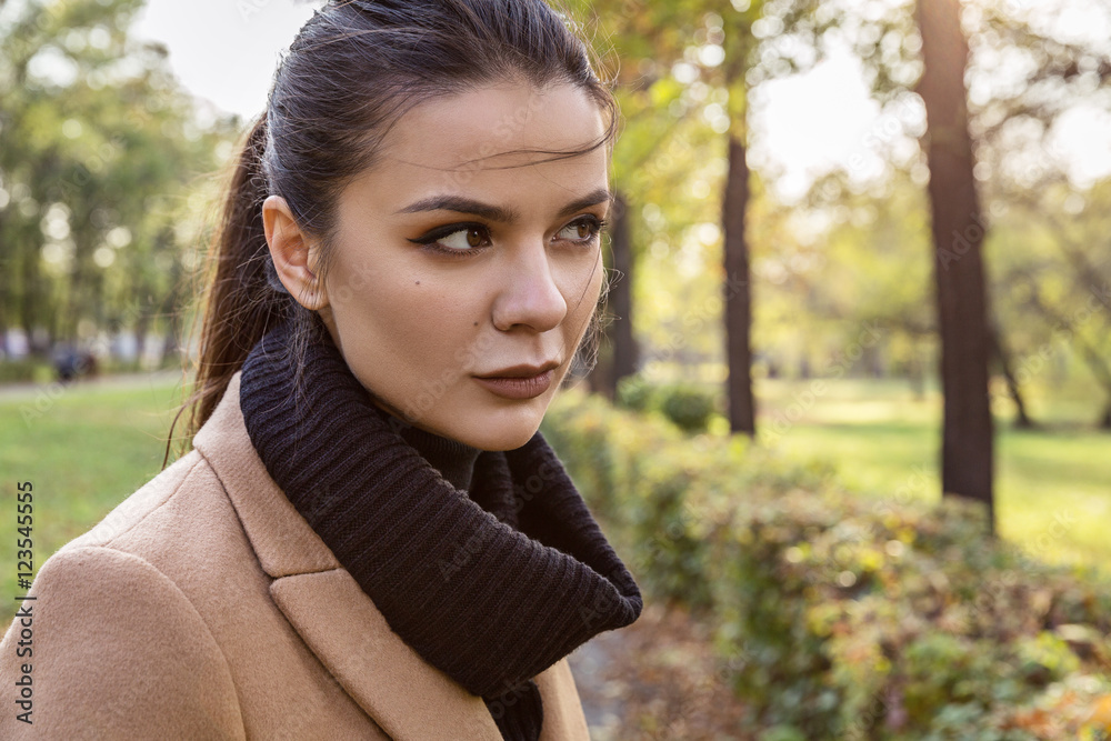 Portrait of a brunette in a coat.
Portrait of a brunette in a coat.