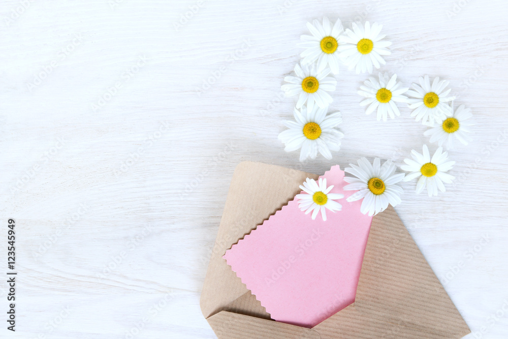 idea messages from your heart/ flat lay with an open letter to the paper, flying off daisies outside view from above idea messages from your heart/ flat lay with an open letter to the paper, flying off daisies outside view from above