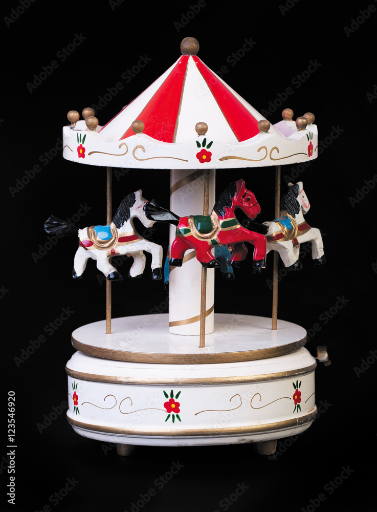 Obraz premium Old Toy wooden carousel on a black background