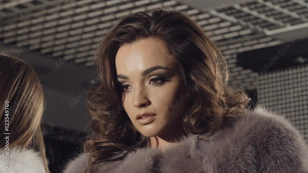Two models posing in rich fur coats in boutique Two models posing in rich fur coats in boutique