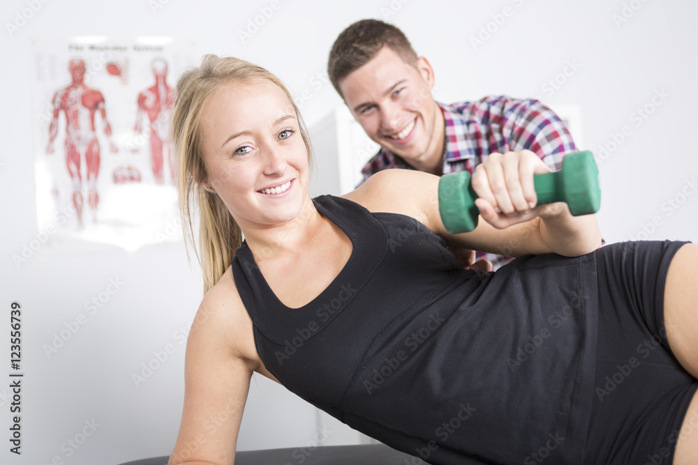 Obraz premium male physio therapist and woman helping patient