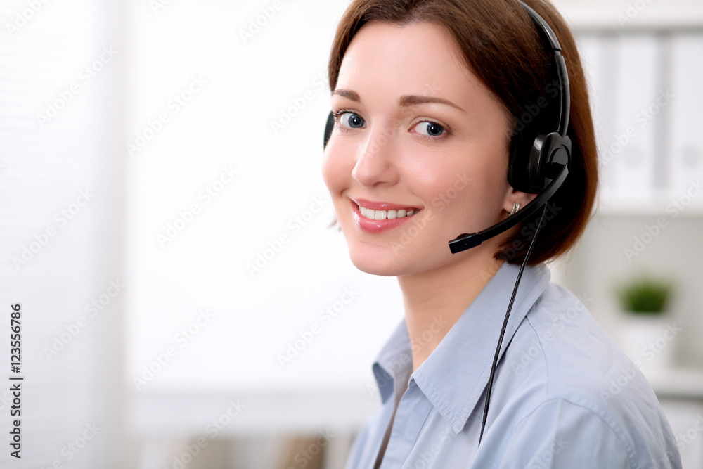 Young beautiful business woman in headset. Call center. Young beautiful business woman in headset. Call center.