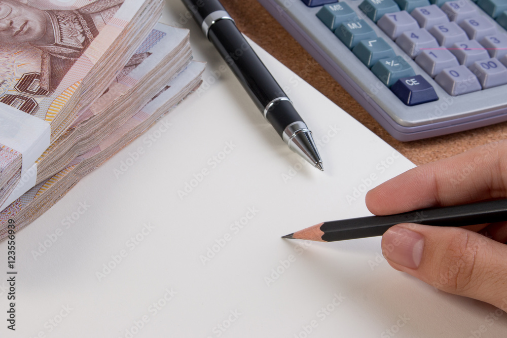 Business money desk concept. Calculator, pen and money on desk with copy space for text. Hand holding pen business concept. Business money desk concept. Calculator, pen and money on desk with copy space for text. Hand holding pen business concept.