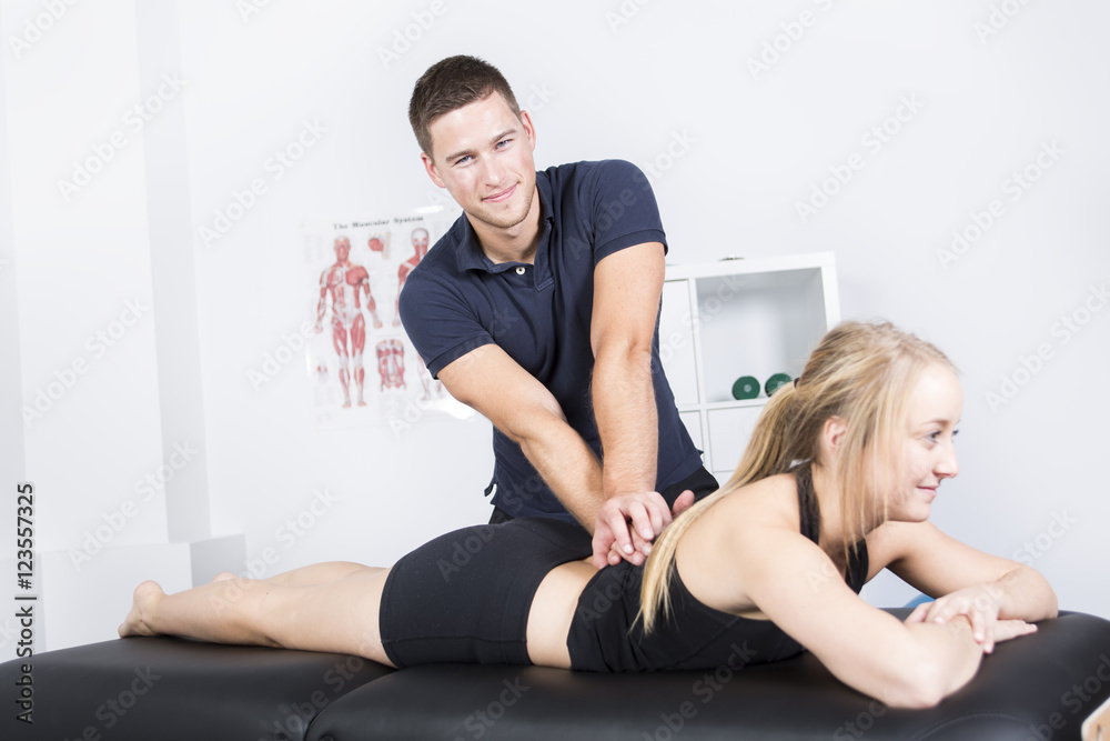 male physio therapist and woman helping patient male physio therapist and woman helping patient