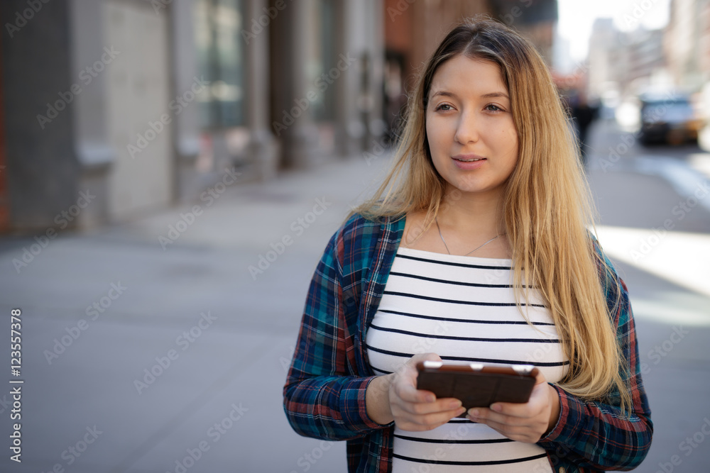 Young woman in city using tablet computer Young woman in city using tablet computer