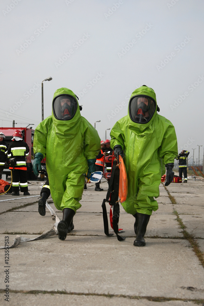 Naklejka premium firemen in action, Firefighters exercises train accident, chemical contamination