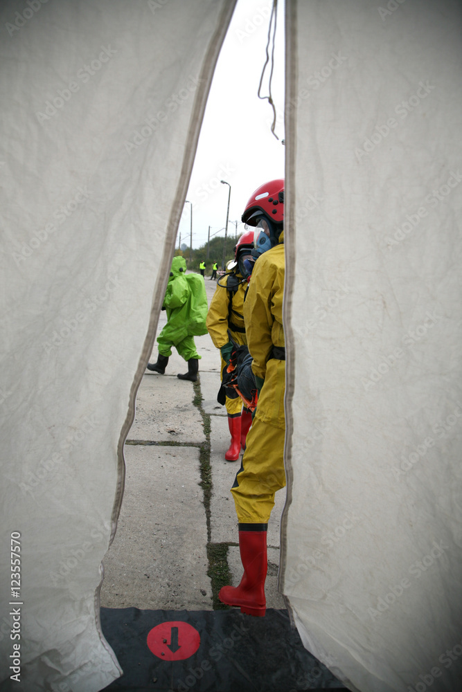 Naklejka premium firemen in action, Firefighters exercises train accident, chemical contamination 