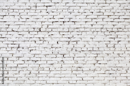 Weathered stained white brick wall, texture grunge background