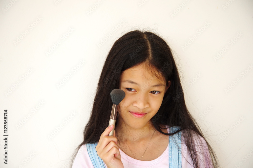 long hair Asian small girl with makeup brush long hair Asian small girl with makeup brush