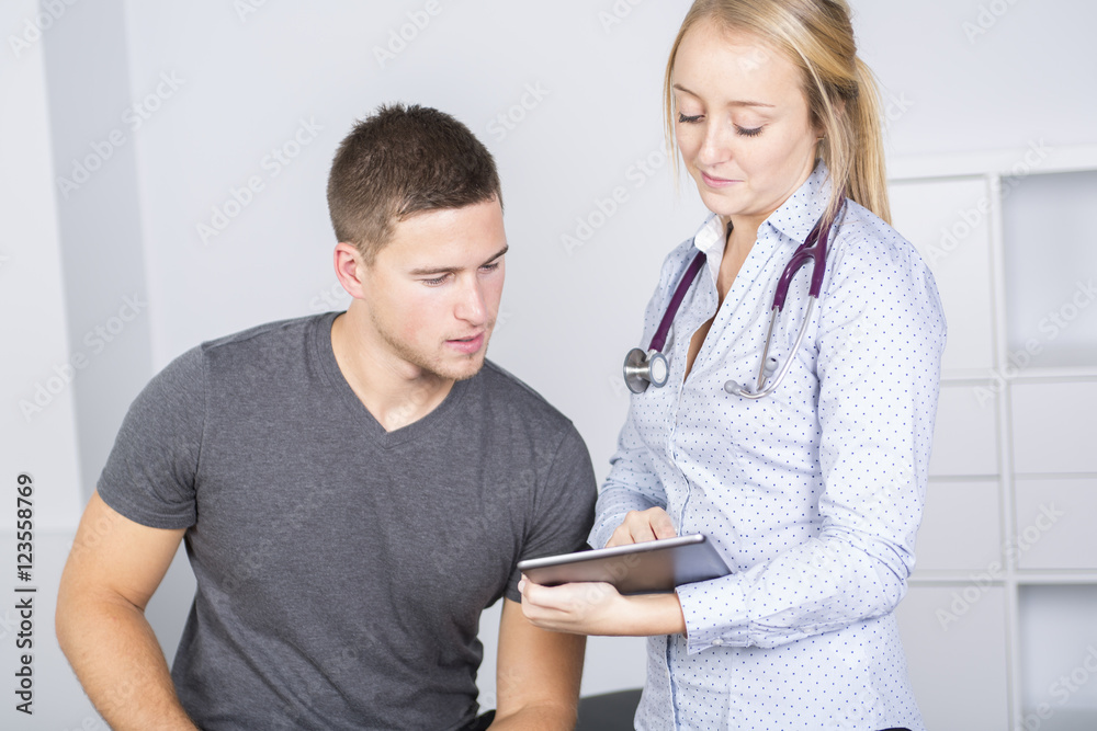 Doctor examining her patient in medical office Doctor examining her patient in medical office