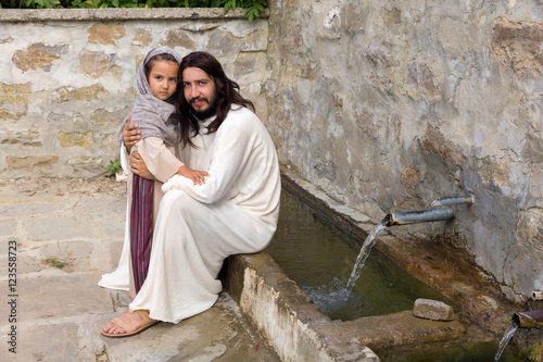 Little girl and Jesus at the water well photo