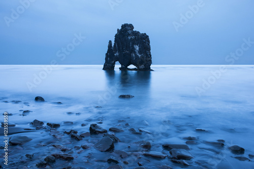Rock formation in lagoon against clear blue sky photo