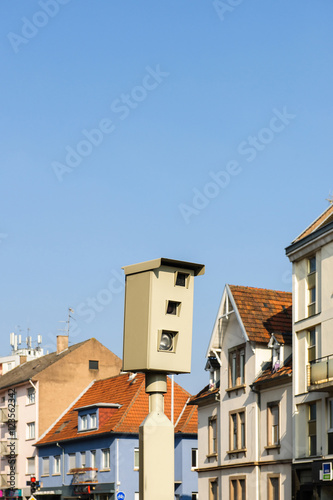 Speed camera traffic control highway road in urban environment city with buildings and clear bue sky behind © ifeelstock