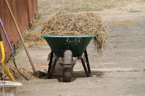 A Wheelbarrow Used for Mucking-out a Horse Stable. Fototapeta