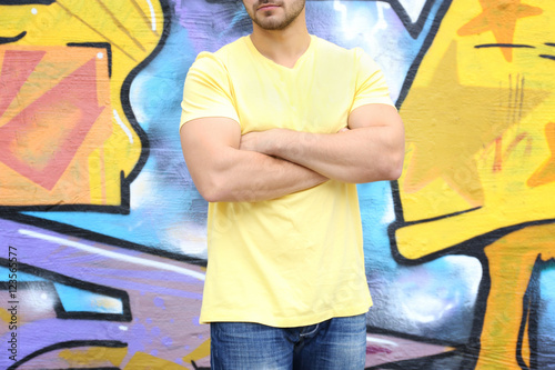 Young man in yellow t-shirt...
