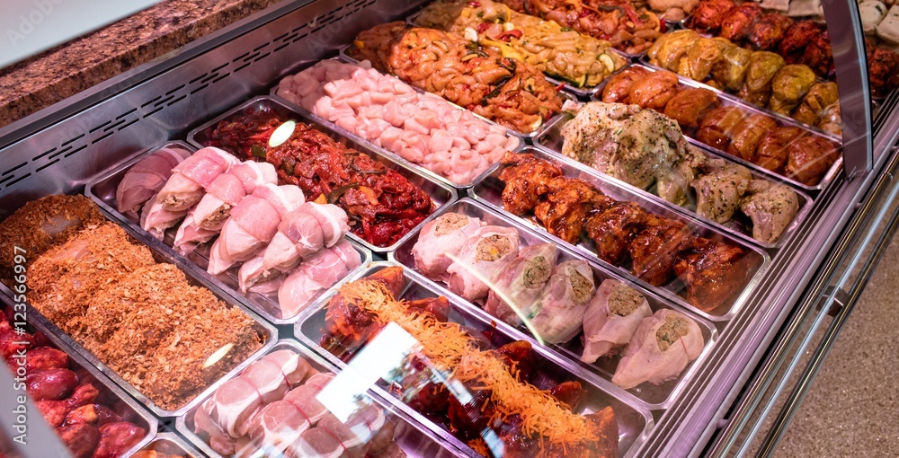 Variety of marinated meat at display counter Variety of marinated meat at display counter